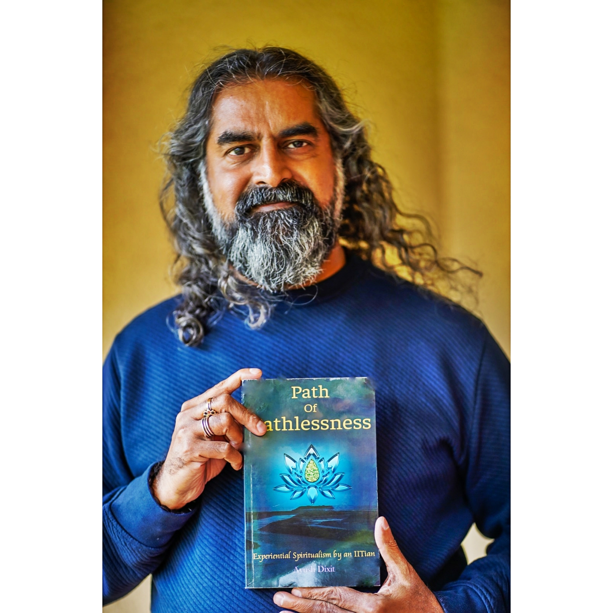 Guruji holding the book Path of Pathlessness